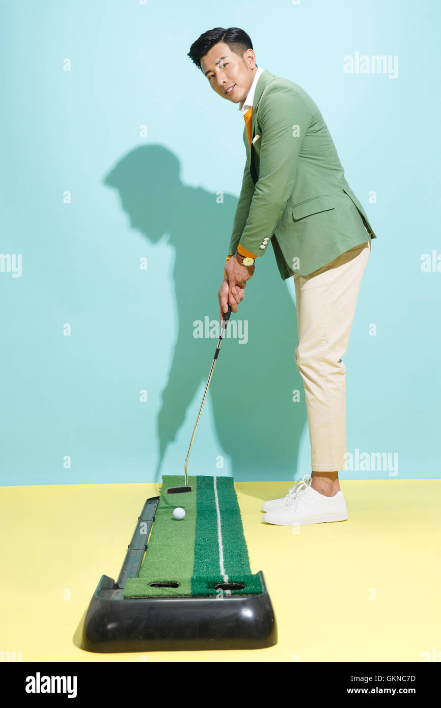 Junger Mann beim Golfen Stockfoto