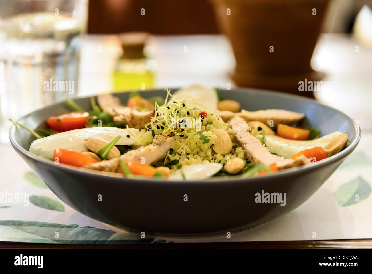Frischer Salat mit Mozzarella, Hähnchen, Tomaten, Mandeln und Zwiebeln Keimen Stockfoto