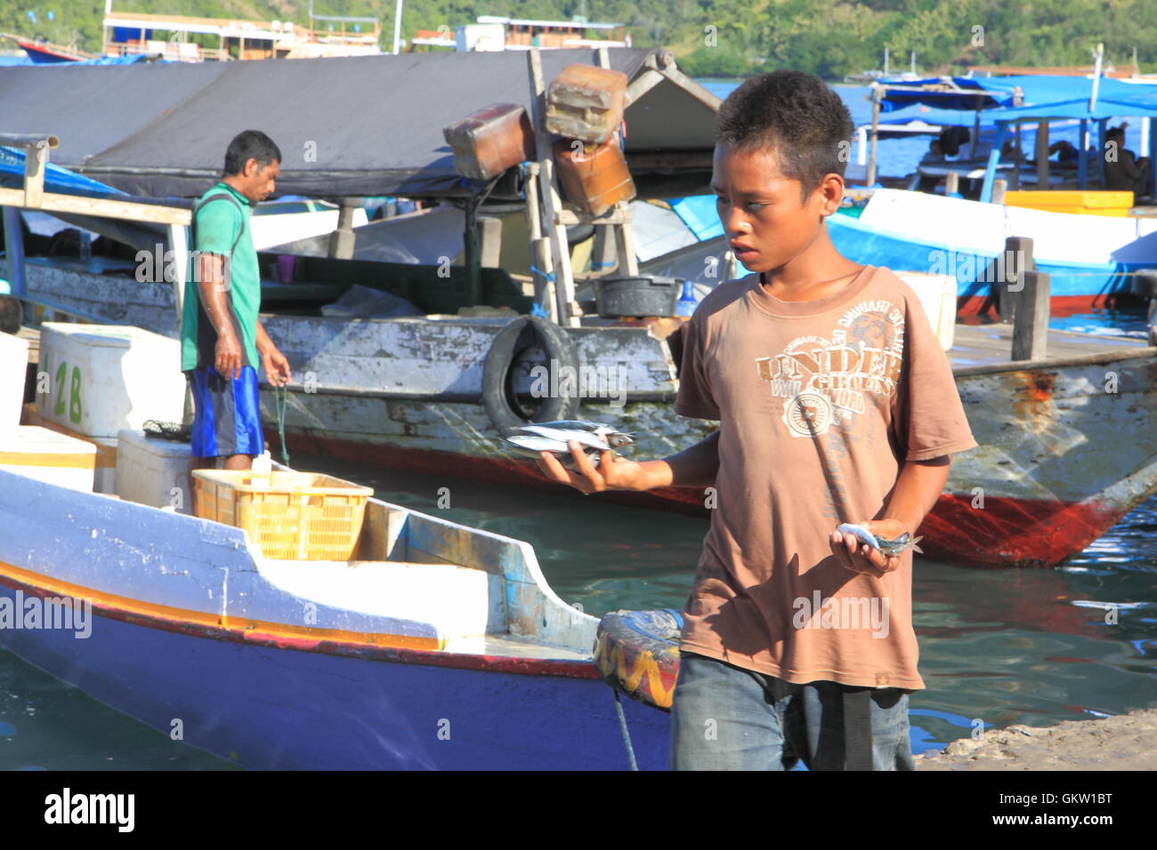 Ein Kind arbeitet an einem Fischerhafen in Labuan Bajo in Flores Indonesien. Stockfoto