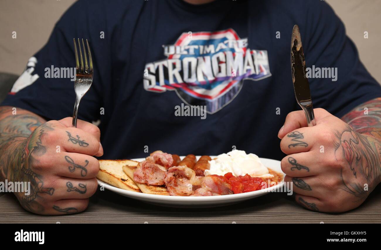 Irische Strongman Sean O'Hagan steckt in einem Frühstück der Champions bei Man Vs Food-Veranstaltung vor der ultimativen Strongman Riesen Wochenende im Crumlin Road Gefängnis in Belfast. Stockfoto