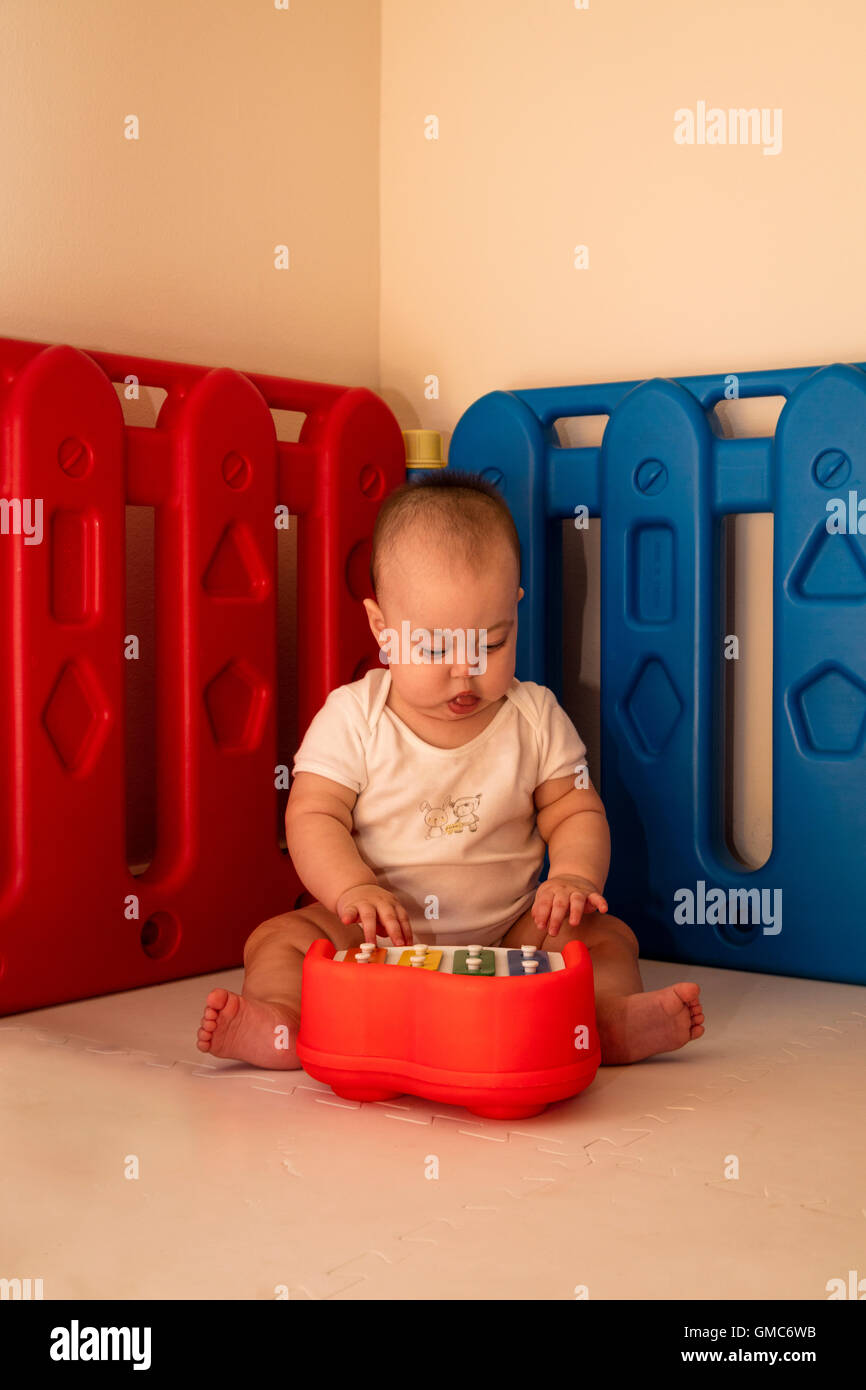 Baby Spielzeug Klavierspiel im Laufstall Stockfoto