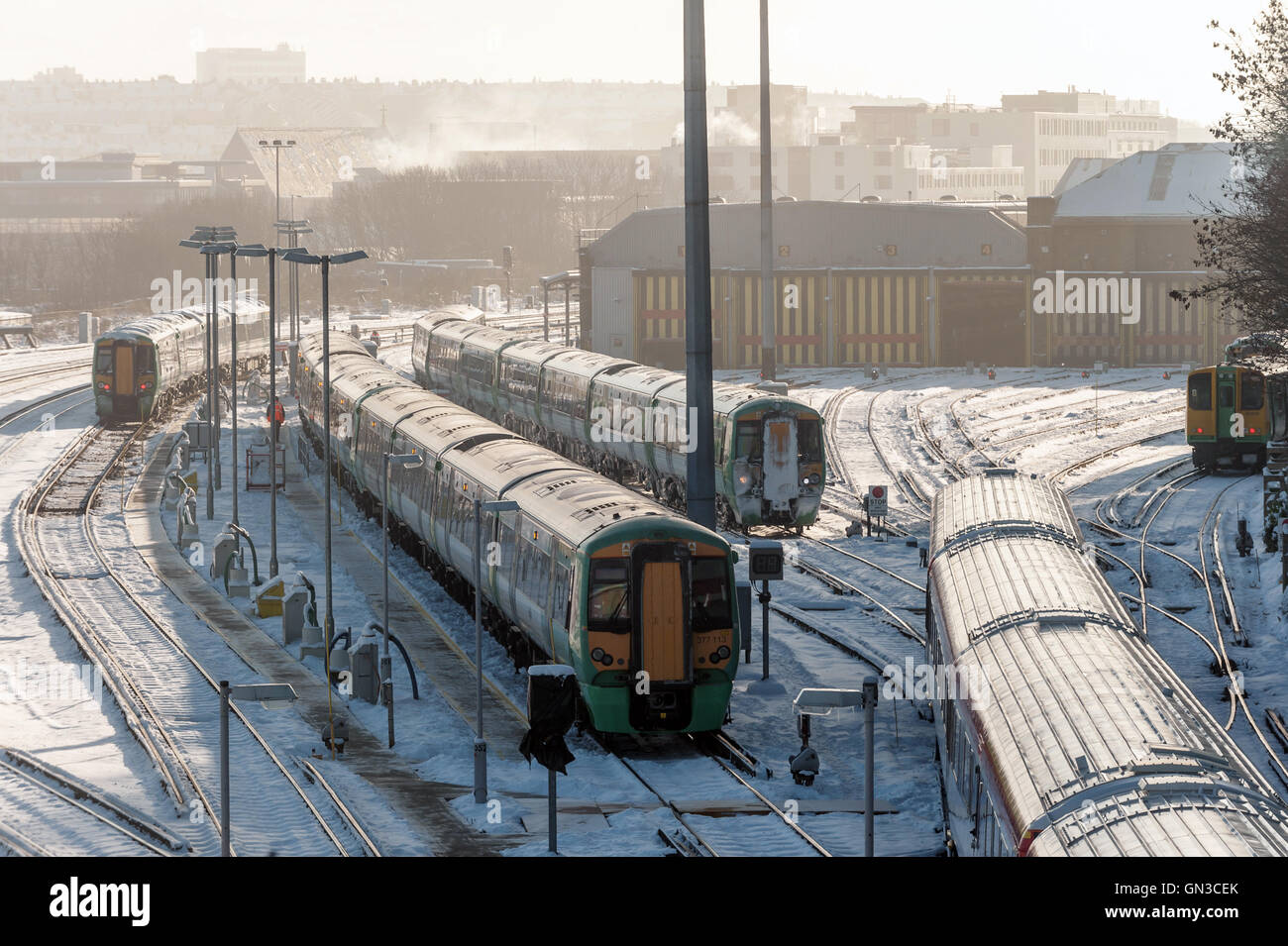 Eisenbahnzüge fahren durch den Schnee an einem Wintermorgen in Brighton Stockfoto