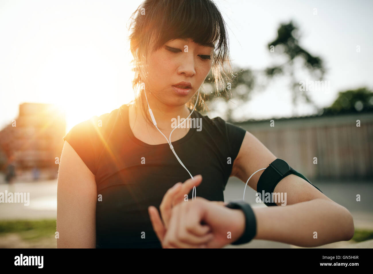 Nahaufnahme einer jungen Sportlerin, die Smartwatch ansieht. Fitness-Frau überwacht ihren Fortschritt auf Smartwatch. Stockfoto