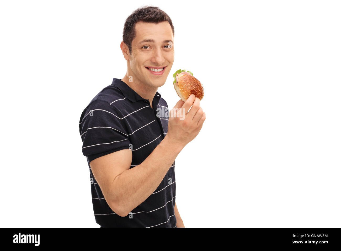 Glücklicher junger Mann Essen einen Sandwich isoliert auf weißem Hintergrund Stockfoto