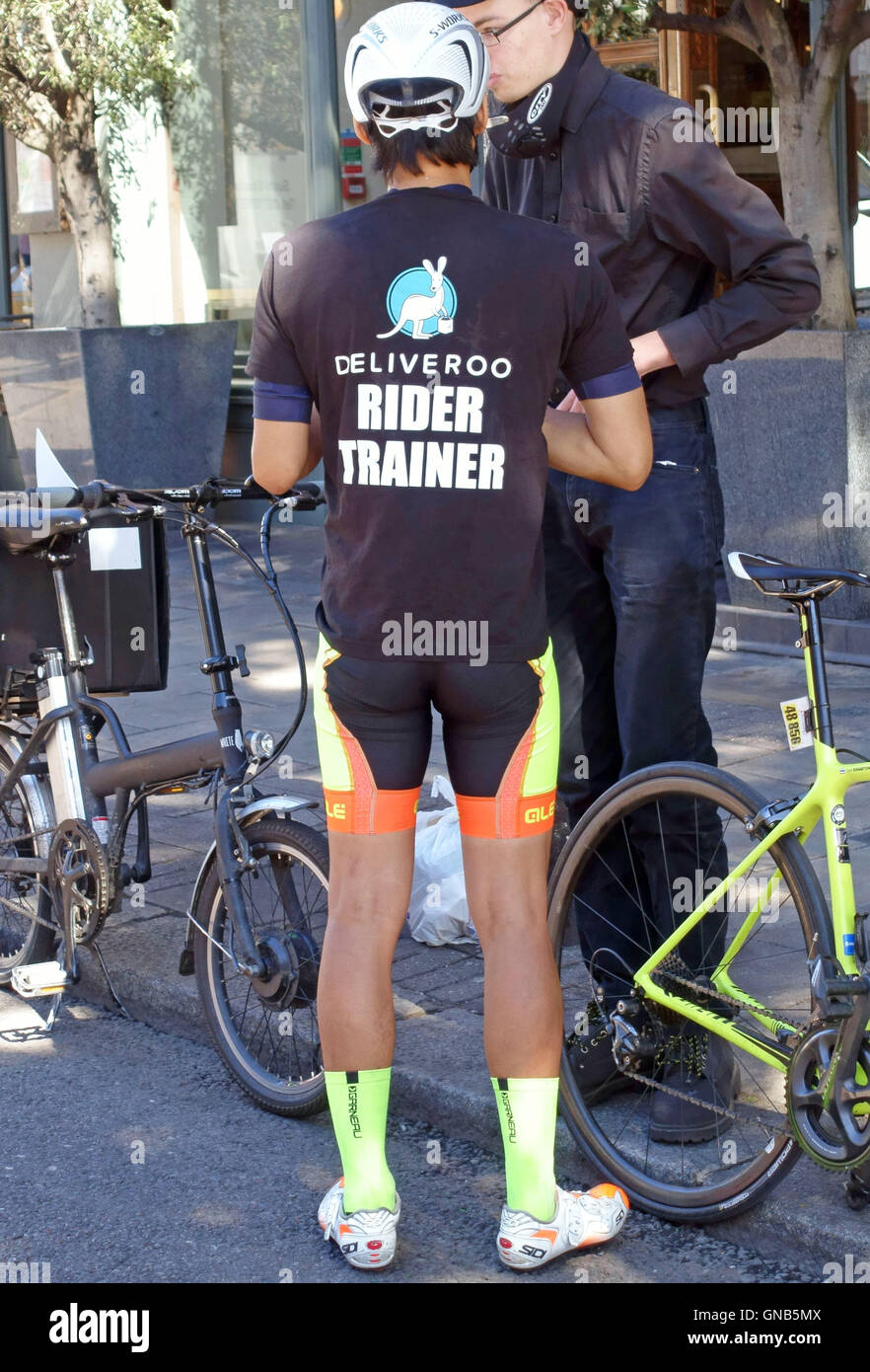 Deliveroo Reiter-Trainer mit Auszubildenden in London Straße Stockfoto