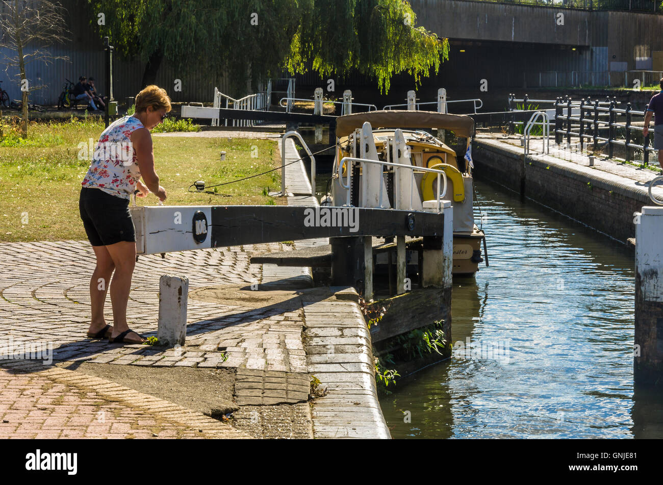 Eine Dame geschlossen eine Schleuse an der Kennet und Avon Kanal in Reading, Berkshire. Stockfoto