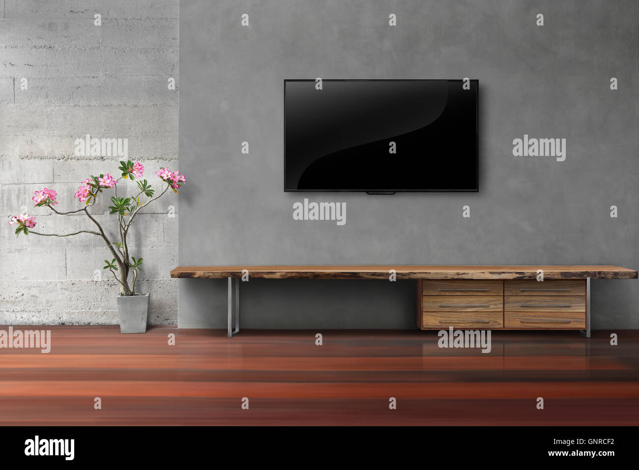 Wohnzimmer led-tv auf Betonwand mit leeren Holzständer Stockfoto