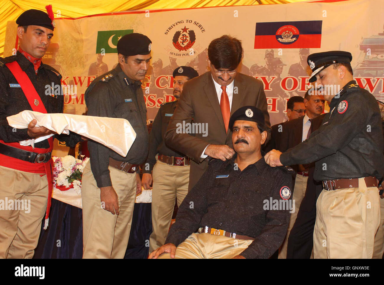 Hauptminister Sindh, Murad Ali Shah fixieren die Rangabzeichen auf den Schultern von Polizeibeamten in den Rang eines Deputy Superintendent der Polizei, während der Zeremonie befördert statt CPO in Karachi auf Donnerstag, 1. September 2016. Stockfoto