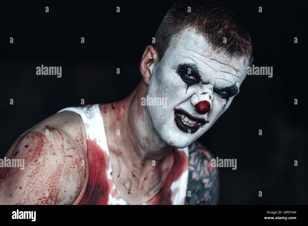 Blutige Clown-Maniac mit Axt Stockfoto