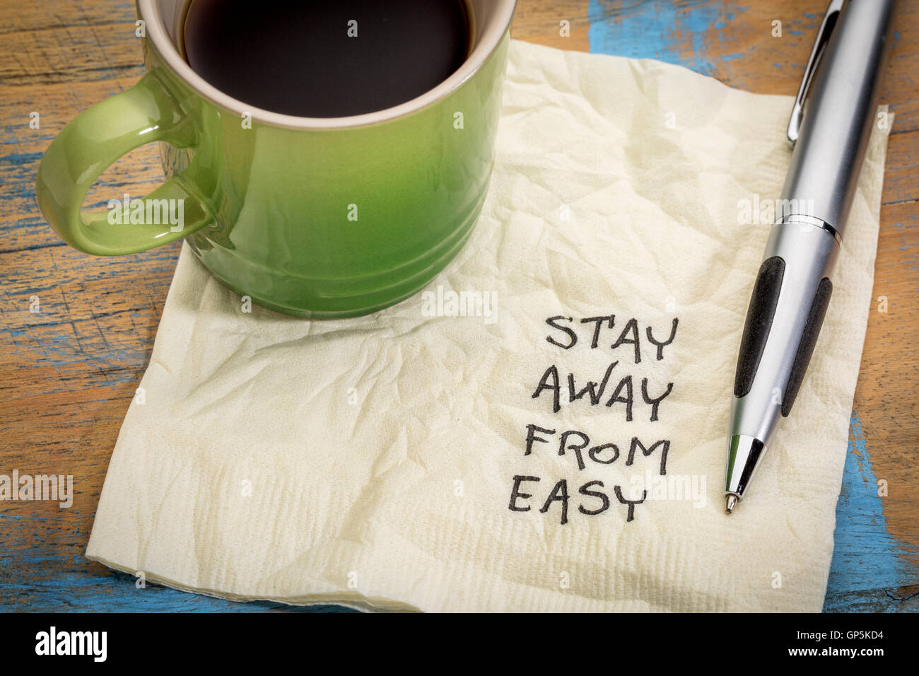 Bleiben Sie weg von der einfachen Beratung oder Erinnerung - Handschrift auf einer Serviette mit einer Tasse Kaffee Stockfoto