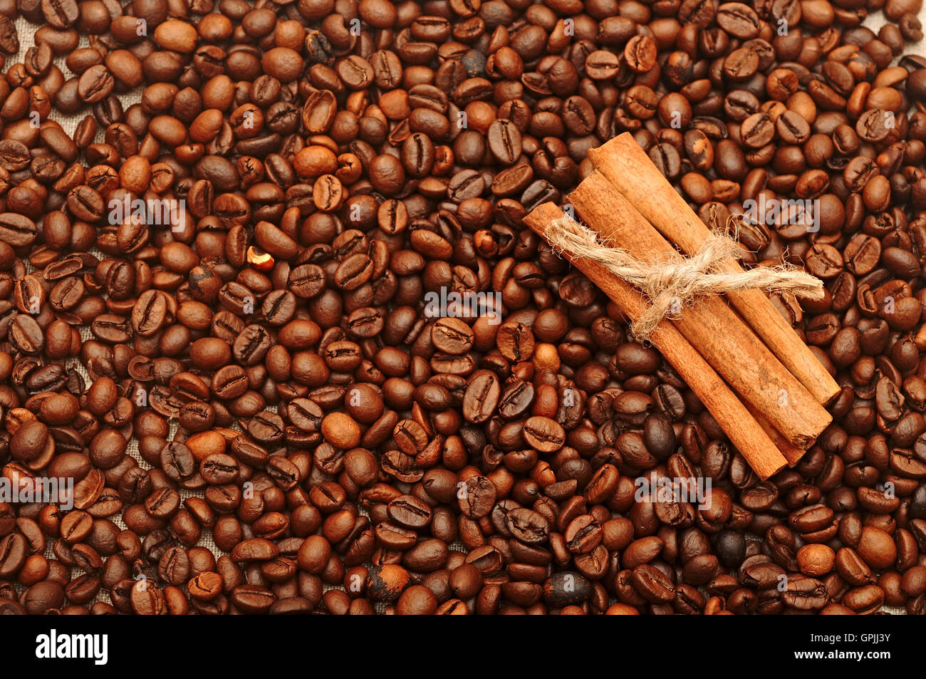 Handvoll aromatische Kaffeebohnen mit Zimt Stockfoto
