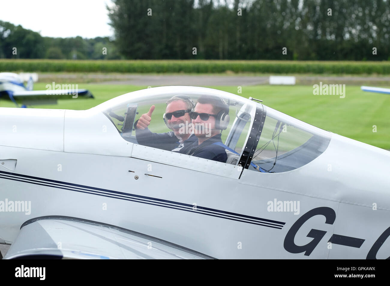 Shobdon Flugplatz, Herefordshire, UK - September 2016 - Dominic Crossan (pilot im Vordergrund) und Roger Scholes (Navigator hinter) feiern gewinnen diesjährigen King Cup Luftrennen vor ihre Vans RV-6 Flugzeuge. Das Air Race ist im Besitz der Royal Aero Club und arbeitet auf einer Handicap-Basis mit einer Vielzahl von Flugzeugen des Typs Rennen rund um Pylonen in der Nähe von Shobdon Flugplatz. Des Königs Cup Luftrennen wurde initiiert von König George V und 1922 zum ersten Mal statt. Stockfoto