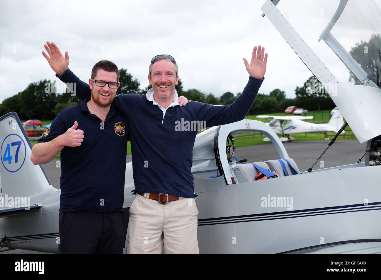 Shobdon Flugplatz, Herefordshire, UK - September 2016 - Dominic Crossan (Pilot auf linken Seite) und Roger Scholes (Navigator rechts) feiern gewinnen diesjährigen King Cup Luftrennen vor ihre Vans RV-6 Flugzeuge. Das Air Race ist im Besitz der Royal Aero Club und arbeitet auf einer Handicap-Basis mit einer Vielzahl von Flugzeugen des Typs Rennen rund um Pylonen in der Nähe von Shobdon Flugplatz. Des Königs Cup Luftrennen wurde initiiert von König George V und 1922 zum ersten Mal statt. Stockfoto