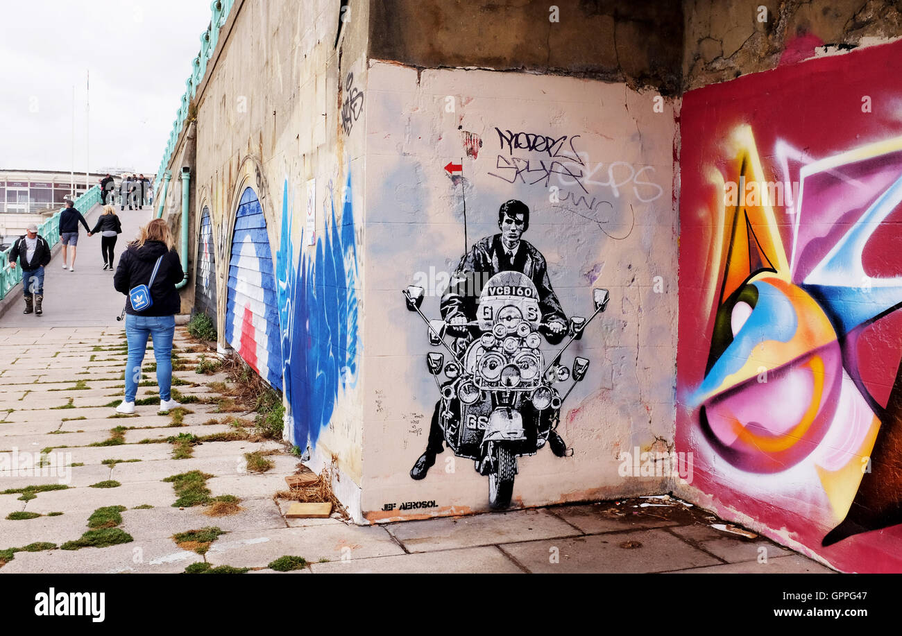 Tribut Graffiti Kunst auf eine Mod auf einem Roller durch Künstler Jef Aerosol entlang der Bögen an Brighton Seafront Stockfoto