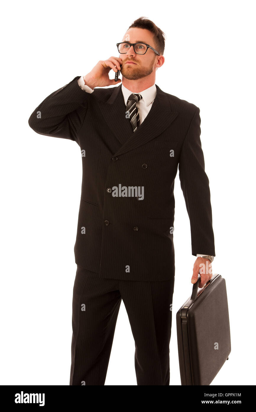 Erfolgreicher Geschäftsmann in formellen Anzug und Aktenkoffer, isoliert über weißen Koffer getrost stehen. Stockfoto