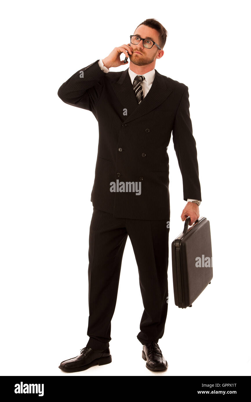 Erfolgreicher Geschäftsmann in formellen Anzug und Aktenkoffer, isoliert über weißen Koffer getrost stehen. Stockfoto