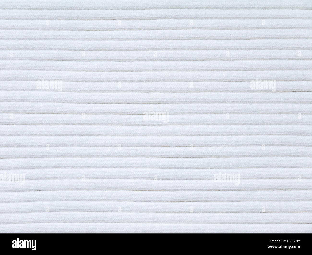 Off-White ribbed gestrickter Baumwolle Stoff kühles Wetter Hintergrund Stockfoto