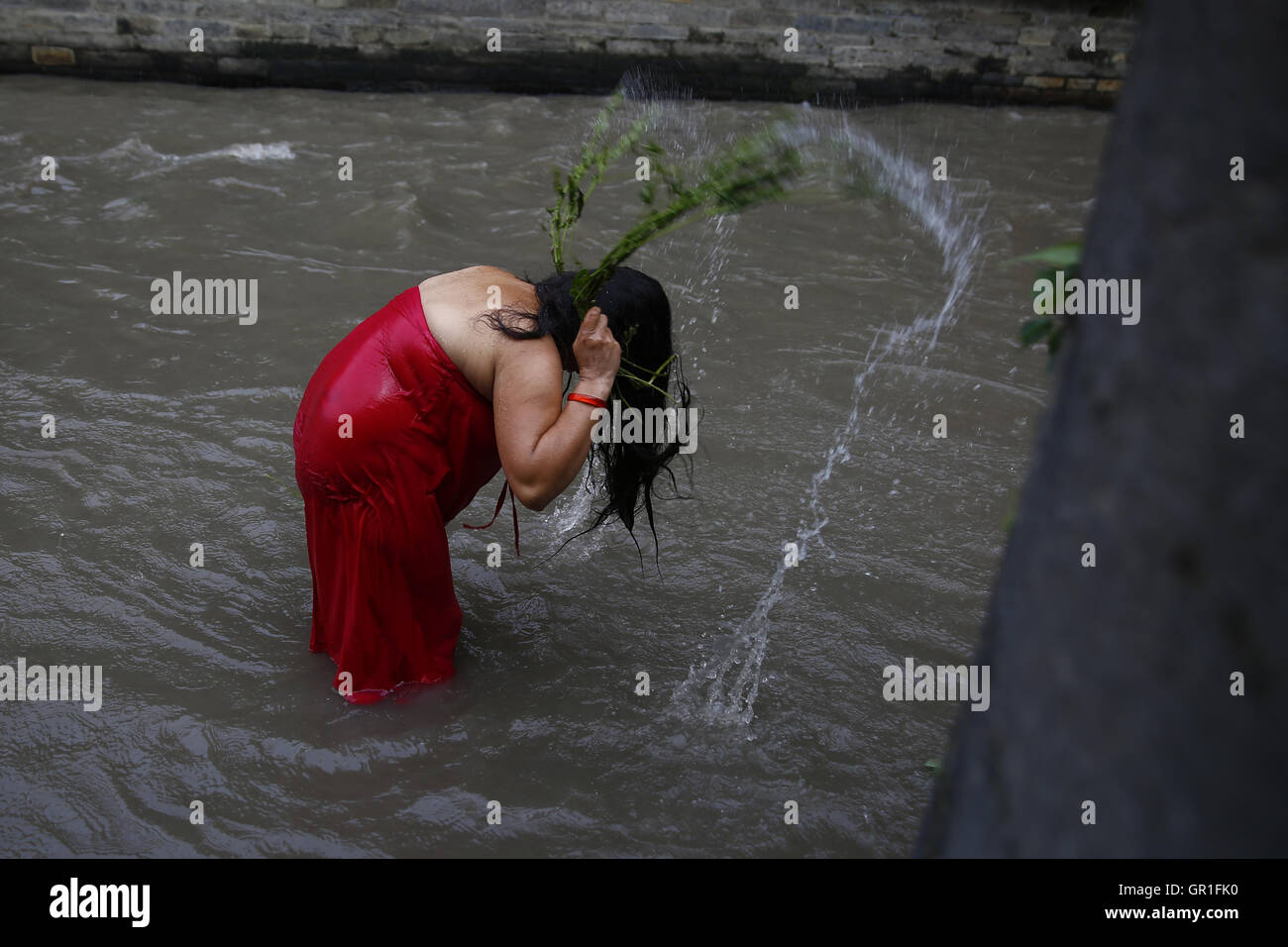 Kathmandu, Nepal. 6. Sep, 2016. Eine nepalesische Hindu braucht Frau ein rituelles Bad, Zurrgurte mit verlässt die Aghada Pflanze, die während der Rishi Panchami Festival am Ufer des Bagmati Fluß innen Pashupathinath Tempel Prämisse, ein UNESCO-Weltkulturerbe als heilig angesehen wird. Rishi Panchami wird beobachtet, um Ende des dreitägigen Teej Festival zu markieren, wenn Frauen Sapta Rishi (sieben heiligen anbeten) am letzten Tag der Unreinheit für das ganze Jahr abwaschen. © Skanda Gautam/ZUMA Draht/Alamy Live-Nachrichten Stockfoto