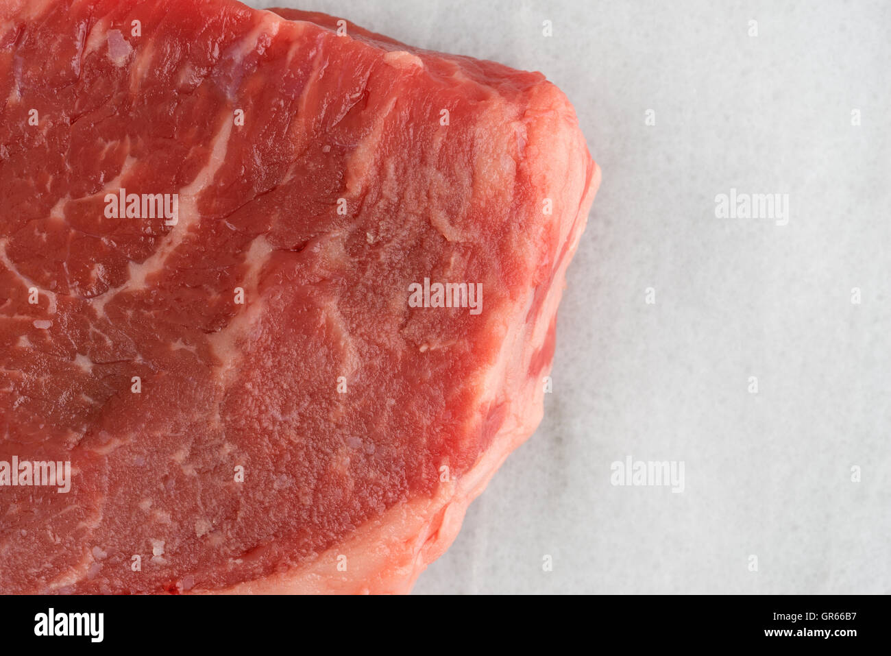 Enge Draufsicht eine alle natürliche Abkürzung Rumpsteak auf ein Schneidebrett aus Marmor. Stockfoto