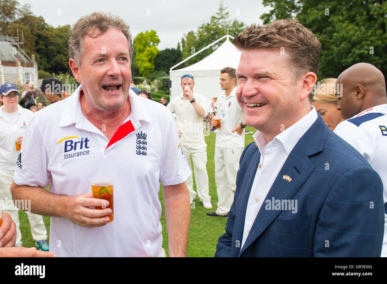 U.S. team Kapitän Piers Morgan (links) mit US-Botschafter Matthew Barzun nach der britischen Presse vs. uns Presse-Spiel veranstaltet von Herrn Barzun an seinem Amtssitz, Winfield House Cricket im Zentrum von London. Stockfoto