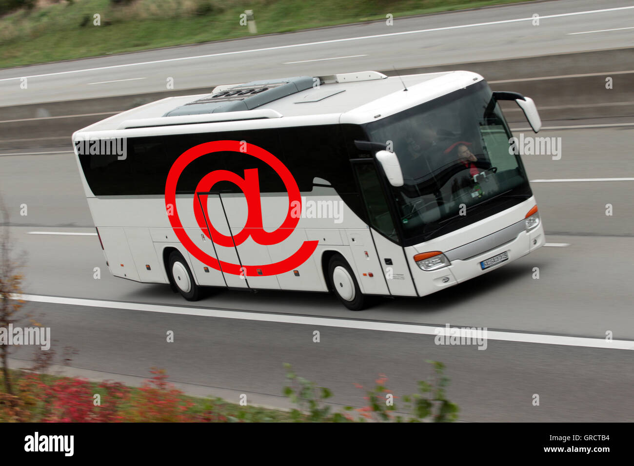 Fern-Bus mit At-Zeichen auf deutschen Autobahnen Stockfoto