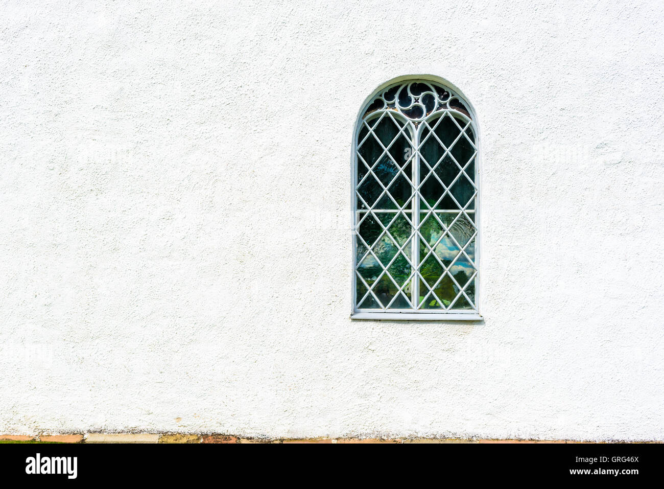 Kirchenfenster auf weißen Wand. Kopieren Sie Raum auf der linken Seite. Stockfoto