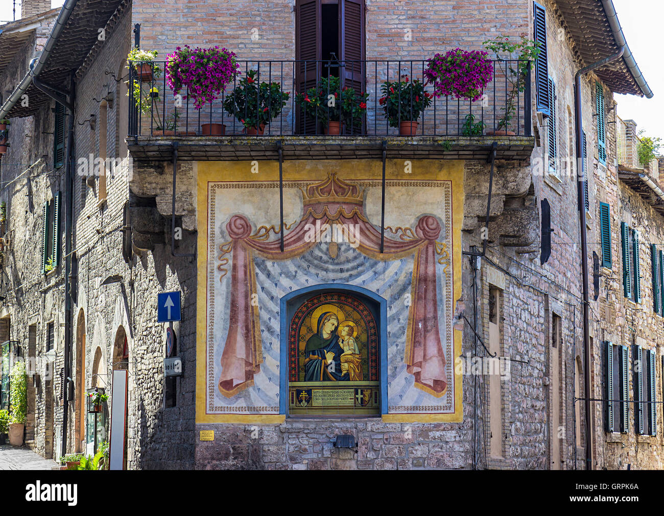 Einblick in eine Straße mit Wand-Fresko in der Stadt Assisi, Italien Stockfoto