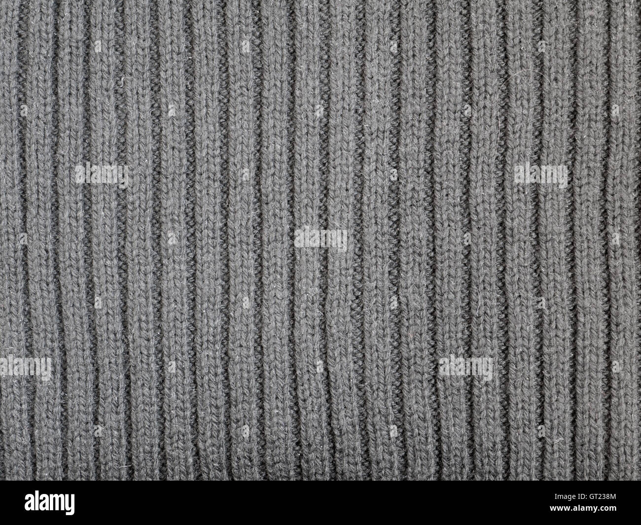 Grau gerippt gestrickter Wolle Stoff Kälte Hintergrund Stockfoto
