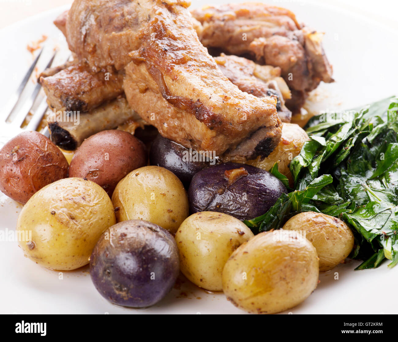 Schweinerippchen mit Fingerling Kartoffeln und Grünkohl Stockfoto