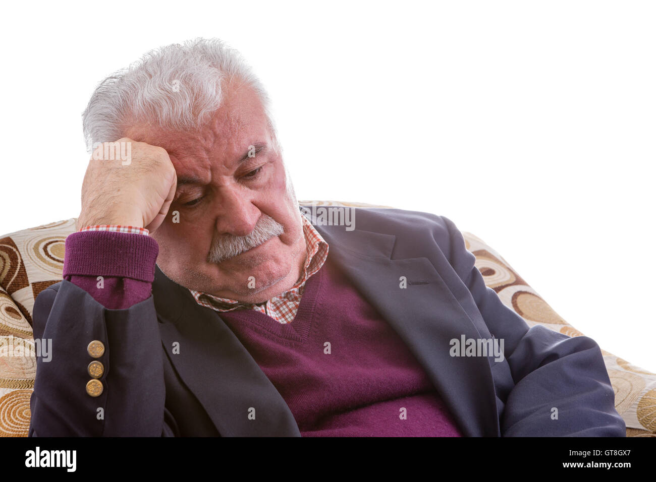 Müde ältere Menschen im Ruhestand Herr sitzen Denken in einem bequemen Sessel, den Kopf auf seine Hand mit niedergeschlagenen Augen ruhen, Stockfoto