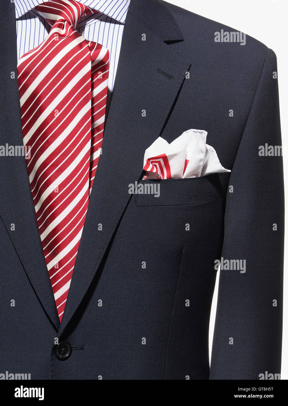 Detail einer dunklen blauen Anzug-Jacke mit rot-weiß gestreifte Krawatte,  Taschentuch und gestreiftes Hemd Stockfotografie - Alamy