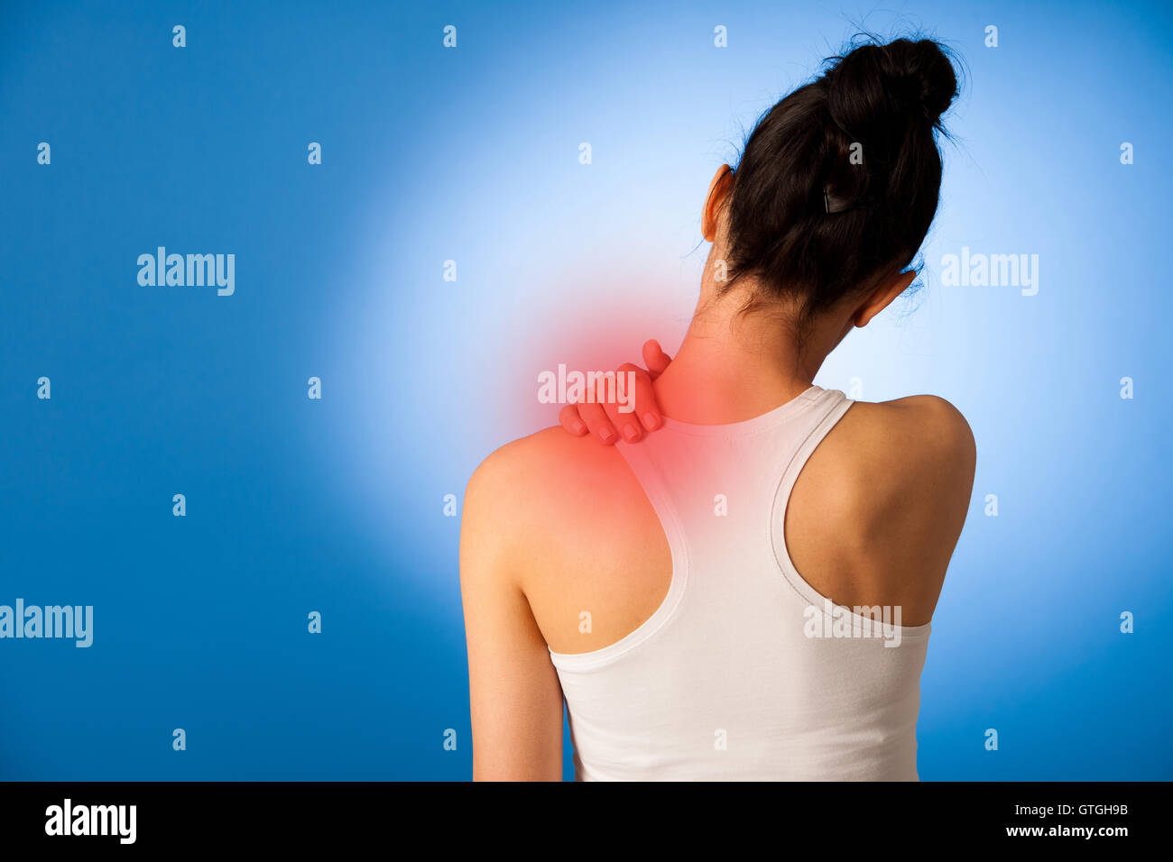 Waman mit Schmerzen im Nacken auf blauem Hintergrund Stockfoto