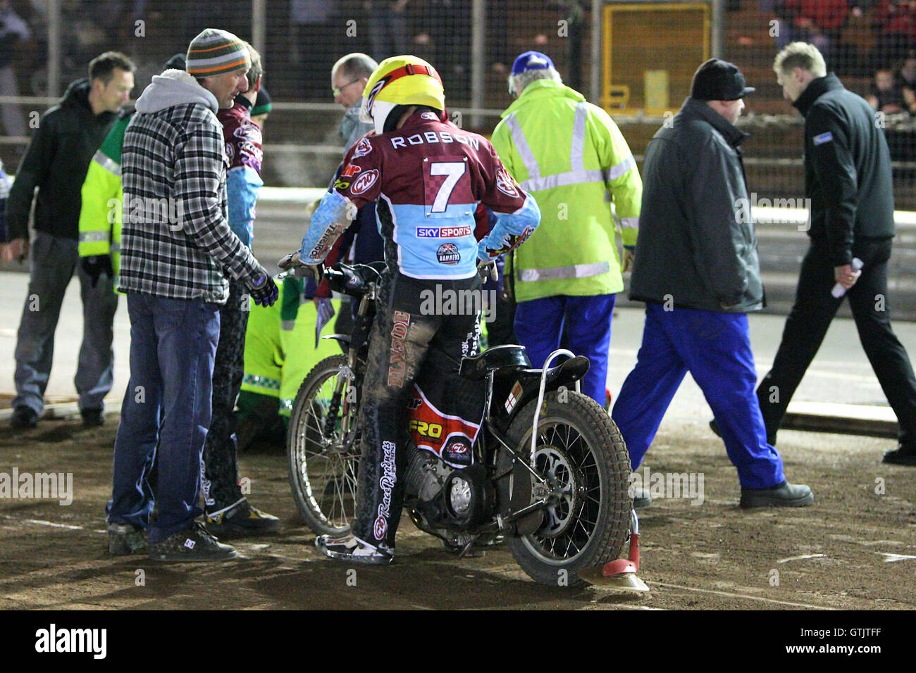 Leigh Lanham von Ipswich ist bei Hitze 8 bei einem Sturz verletzt. Jon Cook vom Seeufer (L) spricht mit seiner Reiterin Stuart Robson (7), die den Vorfall - beteiligt war Ipswich Hexen Vs Lakeside Hämmer - Speedway Challenge Match Hinspiel im Foxhall Stadion, Ipswich, Suffolk - 19.03.09 Stockfoto