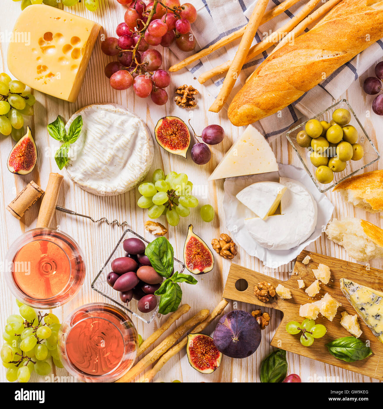 Auswahl an Käse, Obst, Brot, Wein und Snacks auf weiß Stockfoto