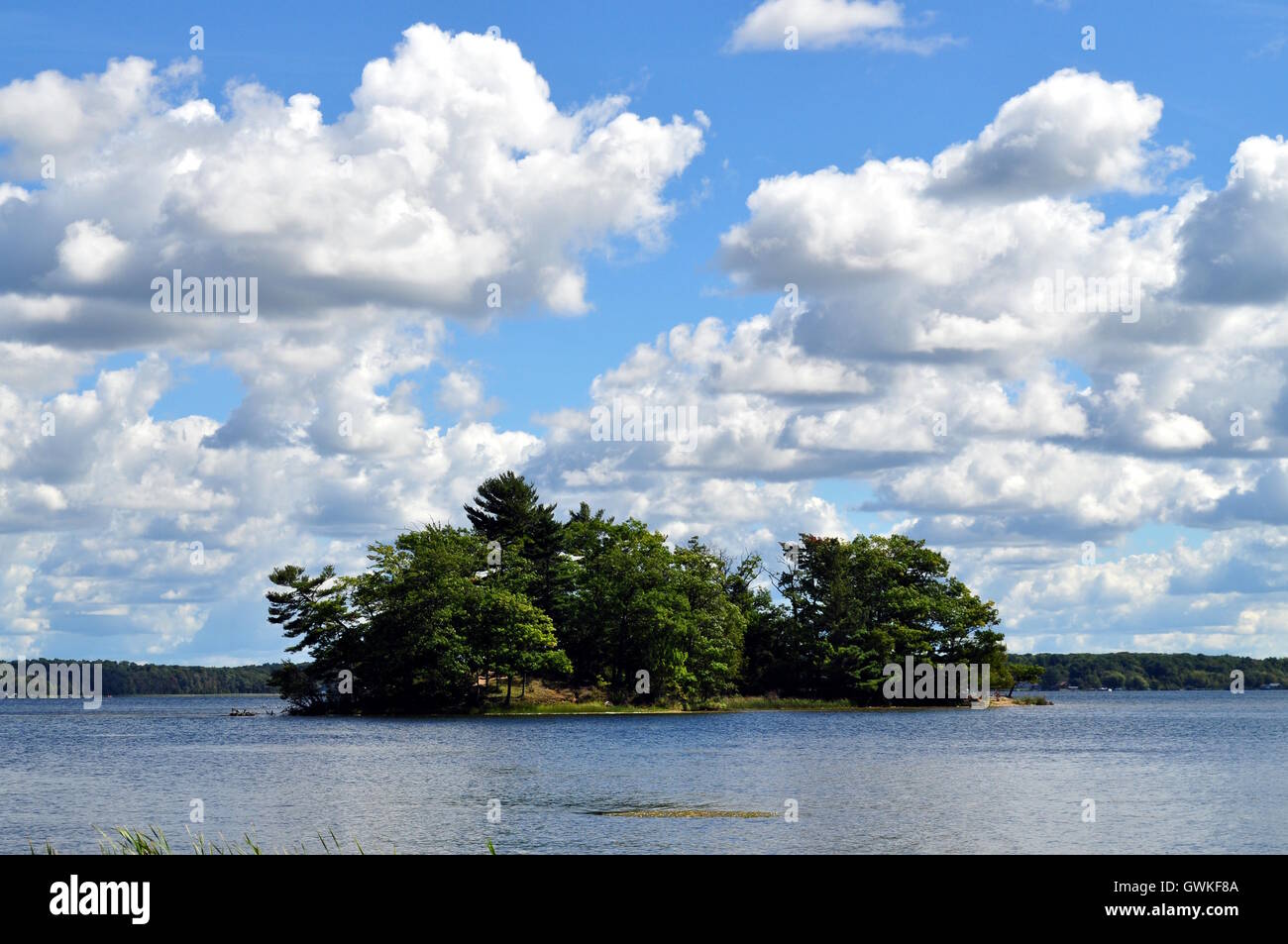 Eine kleine Insel, umgeben von Wasser und blauen Himmel. Stockfoto