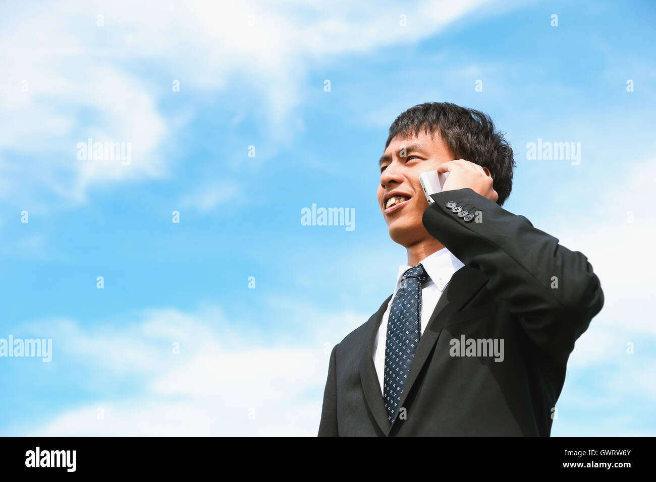 Junge japanische Geschäftsmann auf dem Handy Stockfoto