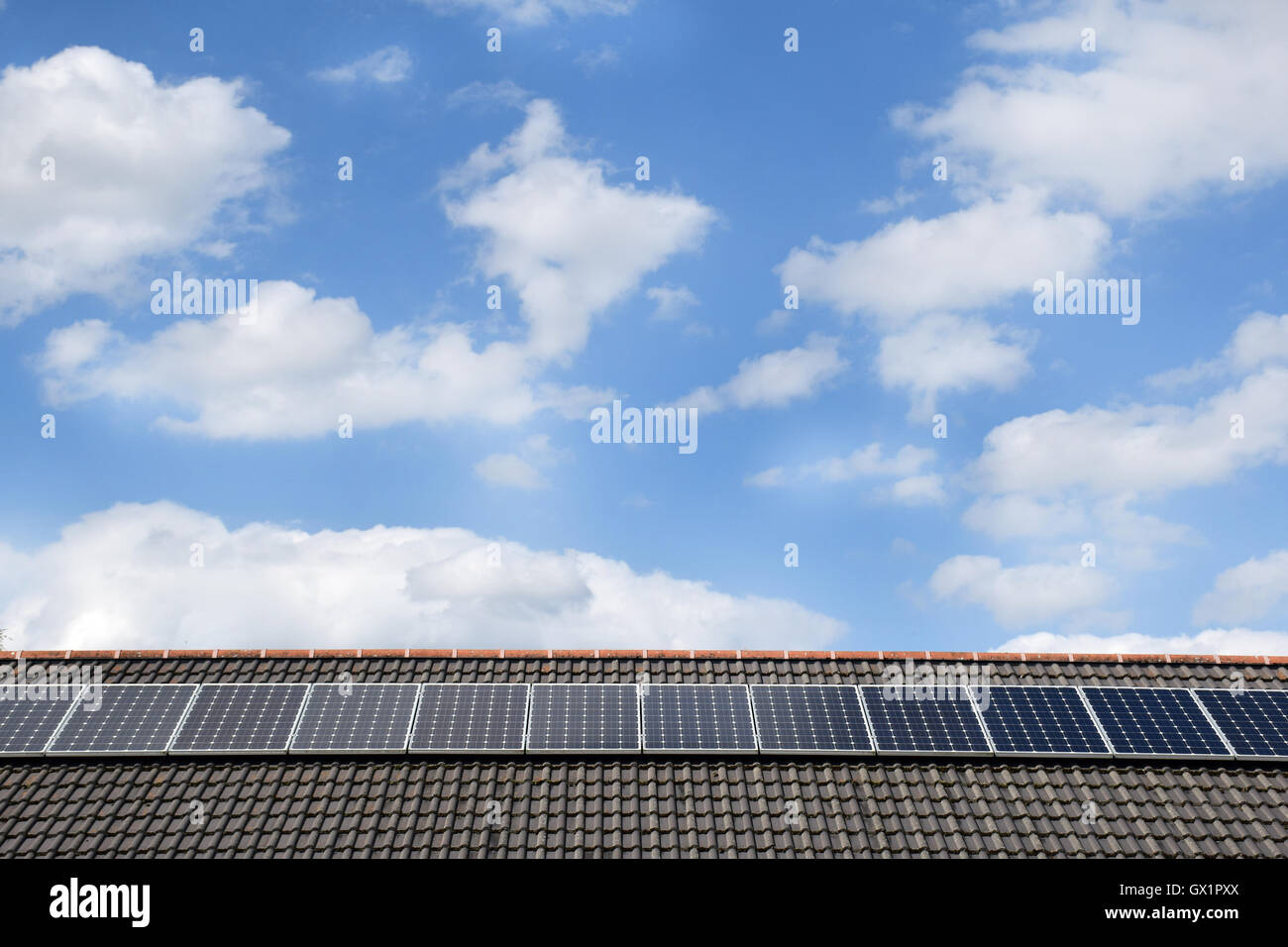 Reihe von solar PV-Module auf einem Dach an einem sonnigen Tag Stockfoto