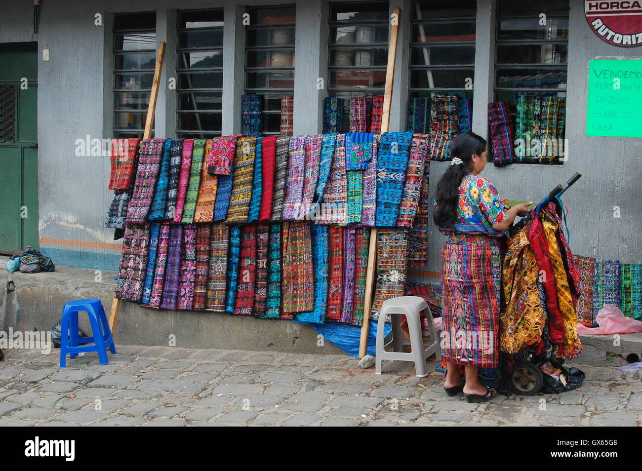 Indigene Frauen verkaufen traditionelle Kleidung in Panajachel, Guatemala Stockfoto