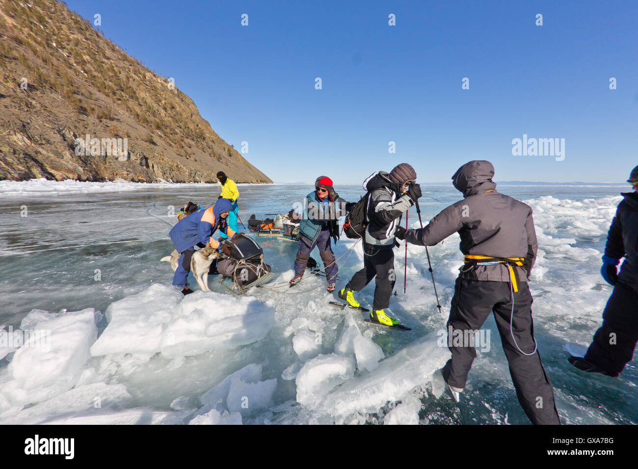 Baikalsee, Russland, März 24. Die Überfahrt durch den Spalt im Eis der Baikalsee großen touristischen Gruppe Menschen Eislaufen und Stockfoto