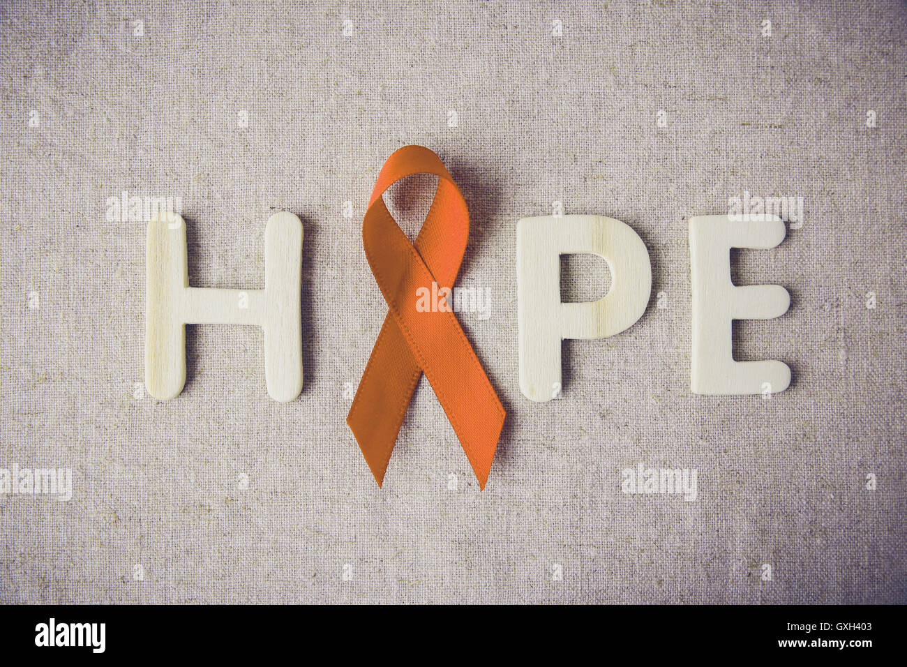 Orange Bänder und Hoffnung Brief auf Muskelaufbau Hintergrund, Leukämie Bewusstsein, Self Injury Awareness Day, Multiple Sklerose Bewusstsein Stockfoto