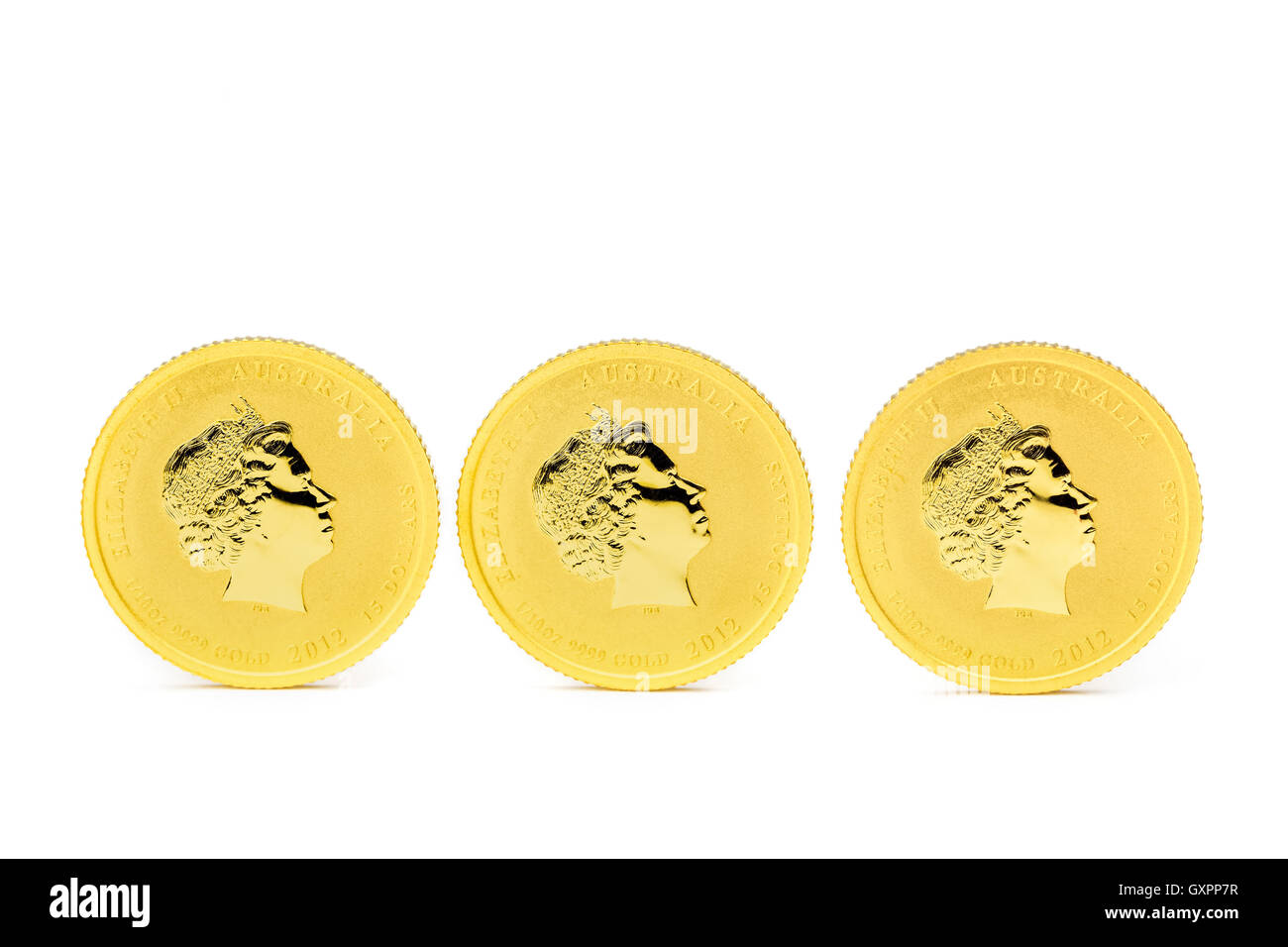 Drei Goldmünzen stehende Dollar isolierten auf weißen Hintergrund Stockfoto
