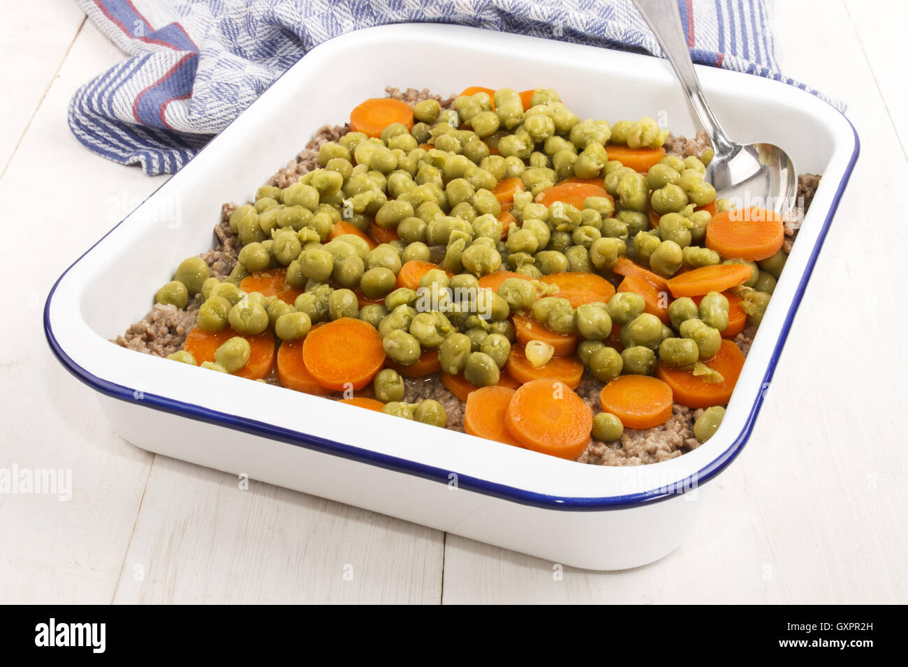 Shepherd es Pie Backen Emaille Bräter mit Hackfleisch, in Scheiben geschnittene Karotten und matschig Erbse Stockfoto