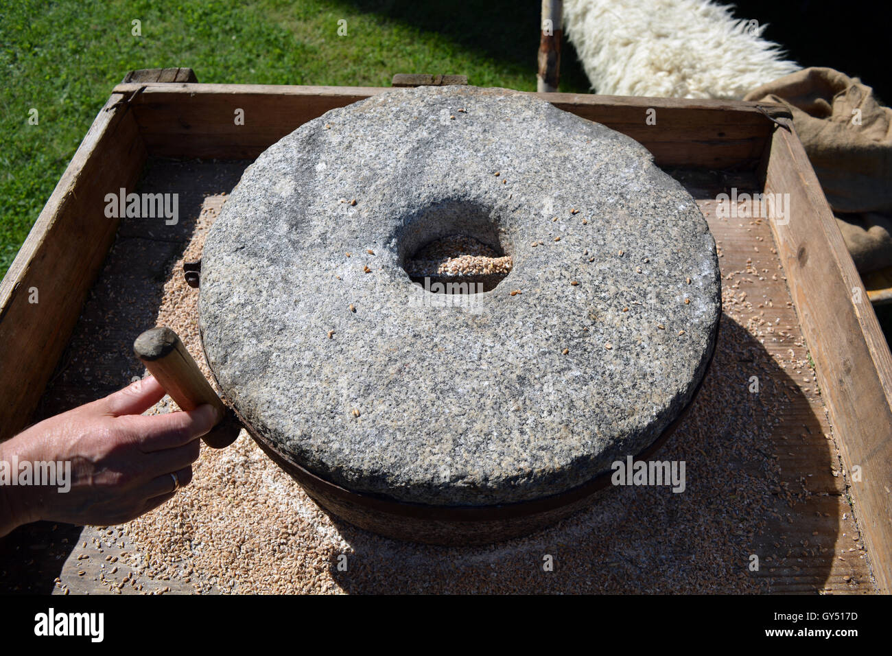 Person mit Ehering ausprobieren Mühlstein in Stadt Handwerksfest Stockfoto