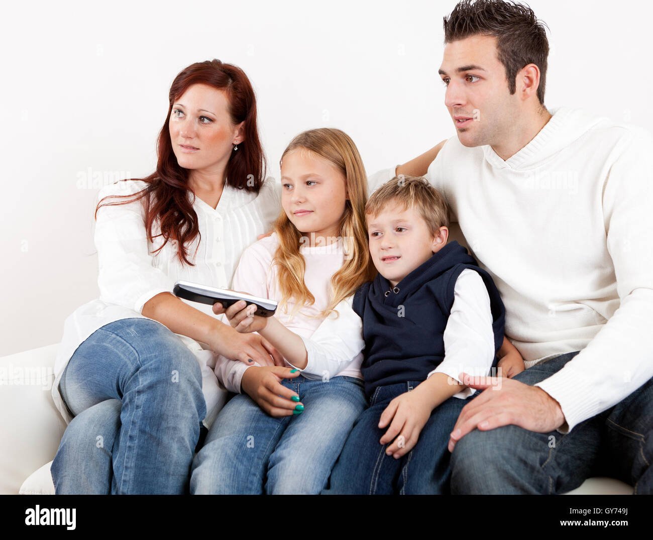 Hat(!) junge Familie vor dem Fernseher zu Hause Stockfoto