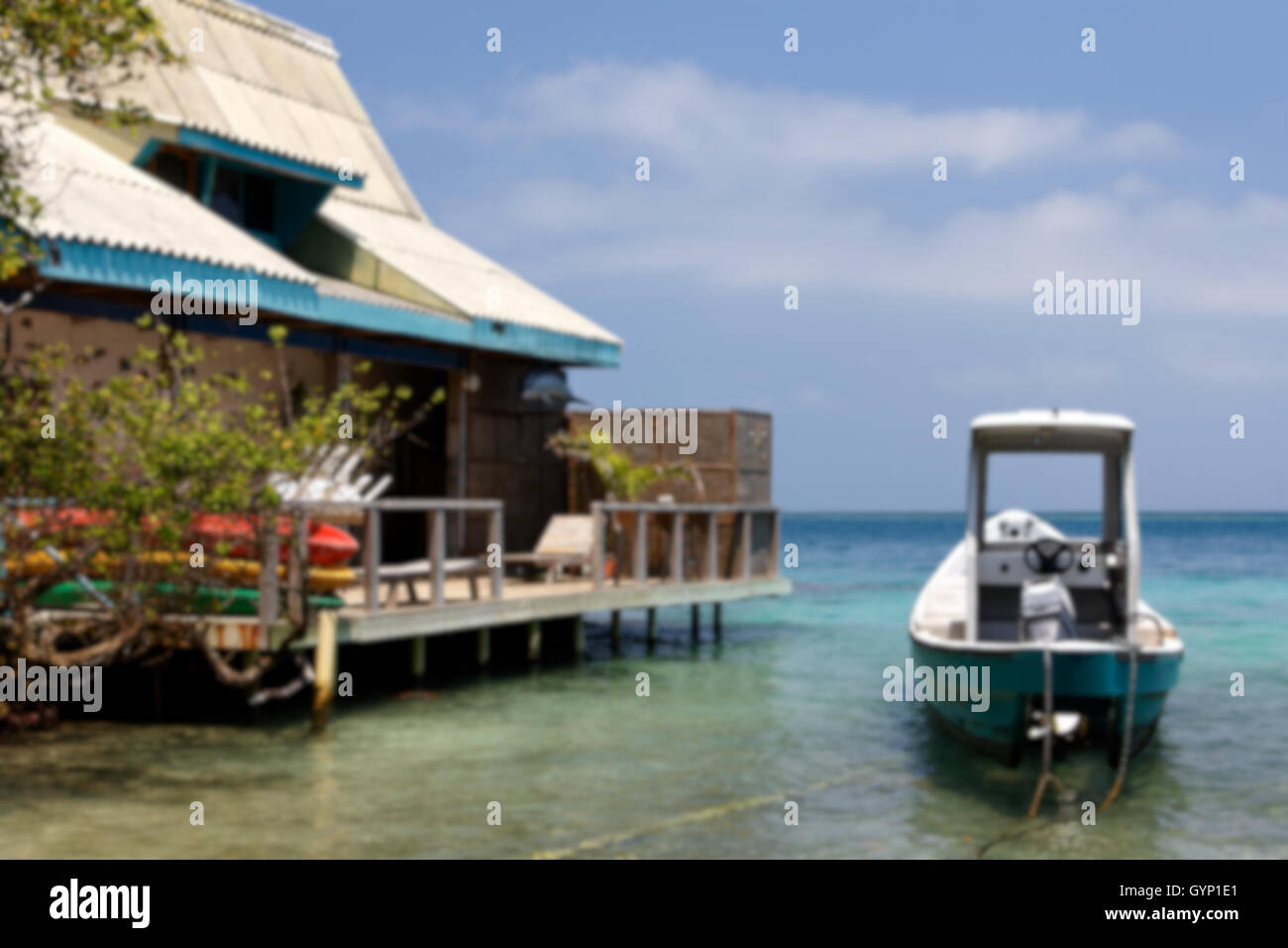 Haus und Boot in einer Lagune in der Karibik ist der Hintergrund jedoch unscharf. Stockfoto