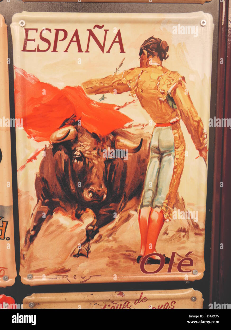 Vintage Poster der Stierkampf in Spanien mit Bull Unterquerung roten Umhang des eleganten geschickte Torero trägt Tracht Stockfoto