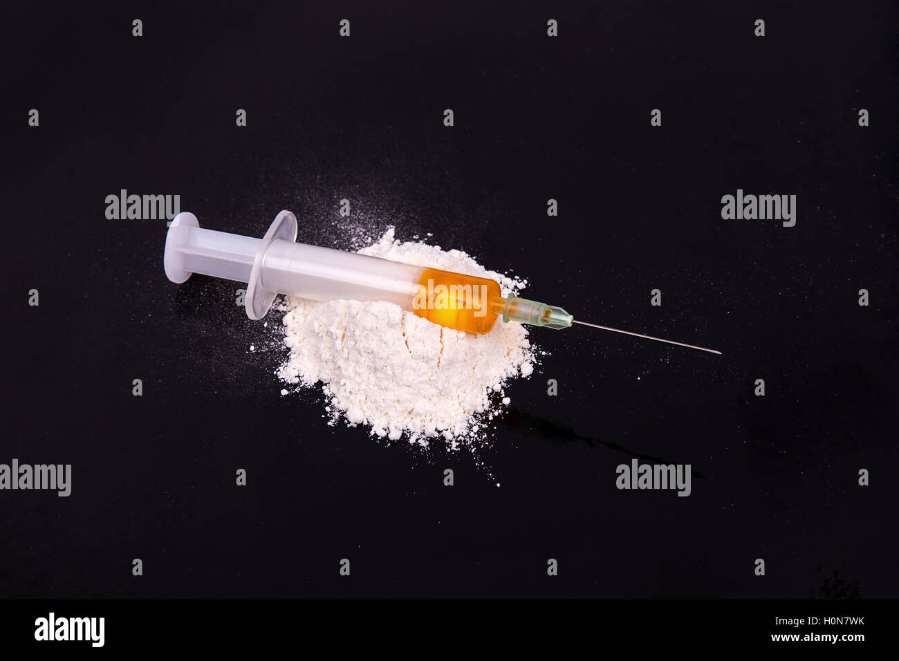 Kokain und alte Spritze auf schwarzem Hintergrund Stockfoto