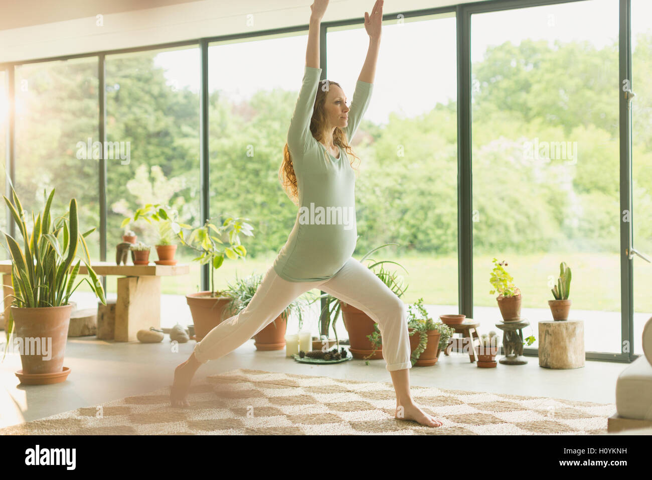 Schwangere Frau praktizieren Yoga Krieger 1 stellen Stockfoto