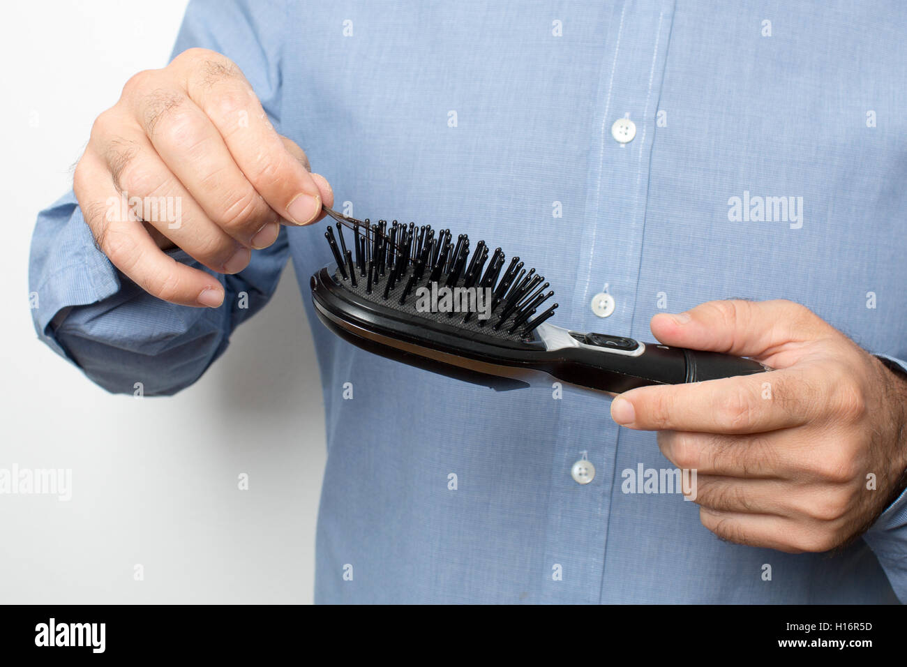 Brünette Mann überprüfen die Haarbürste für Haar Stockfoto