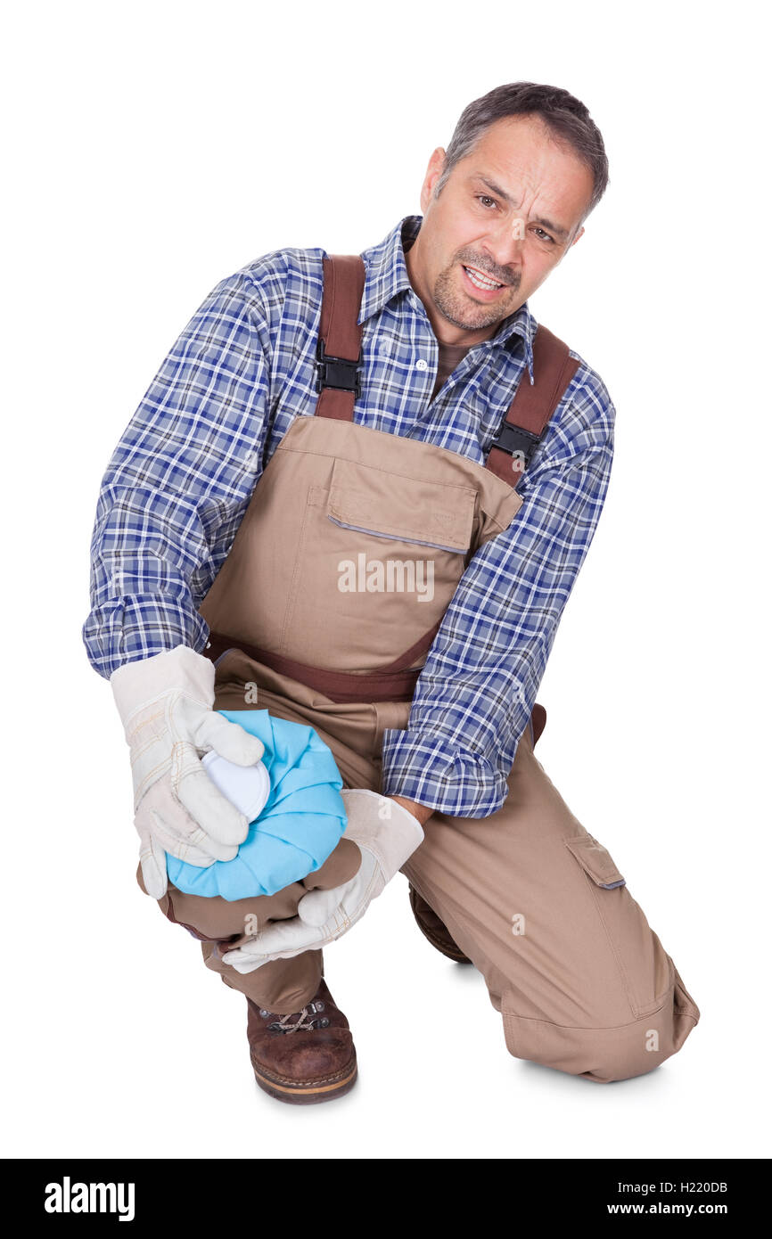 Bau Mann mit Schmerzen im Knie Stockfoto